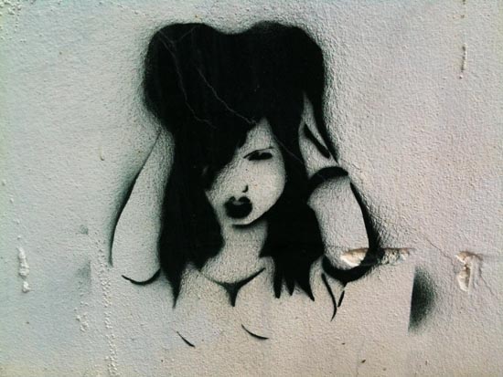 graffiti painting of a girl with long hair holding a flower