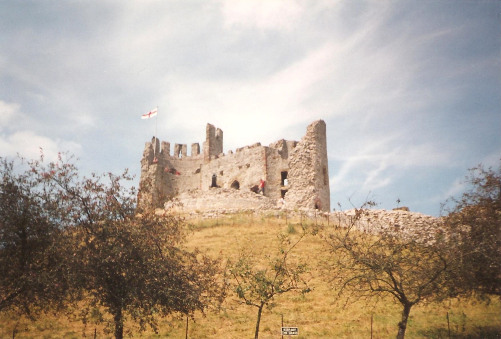 a large castle sitting on top of a hill surrounded by trees
