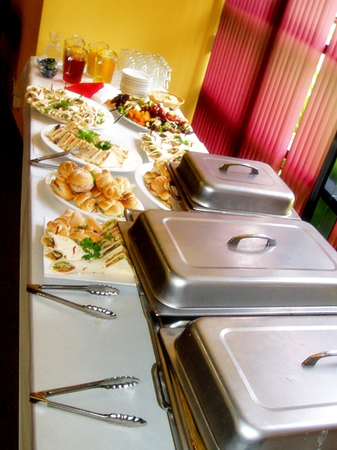 a buffet has many trays and plates of food