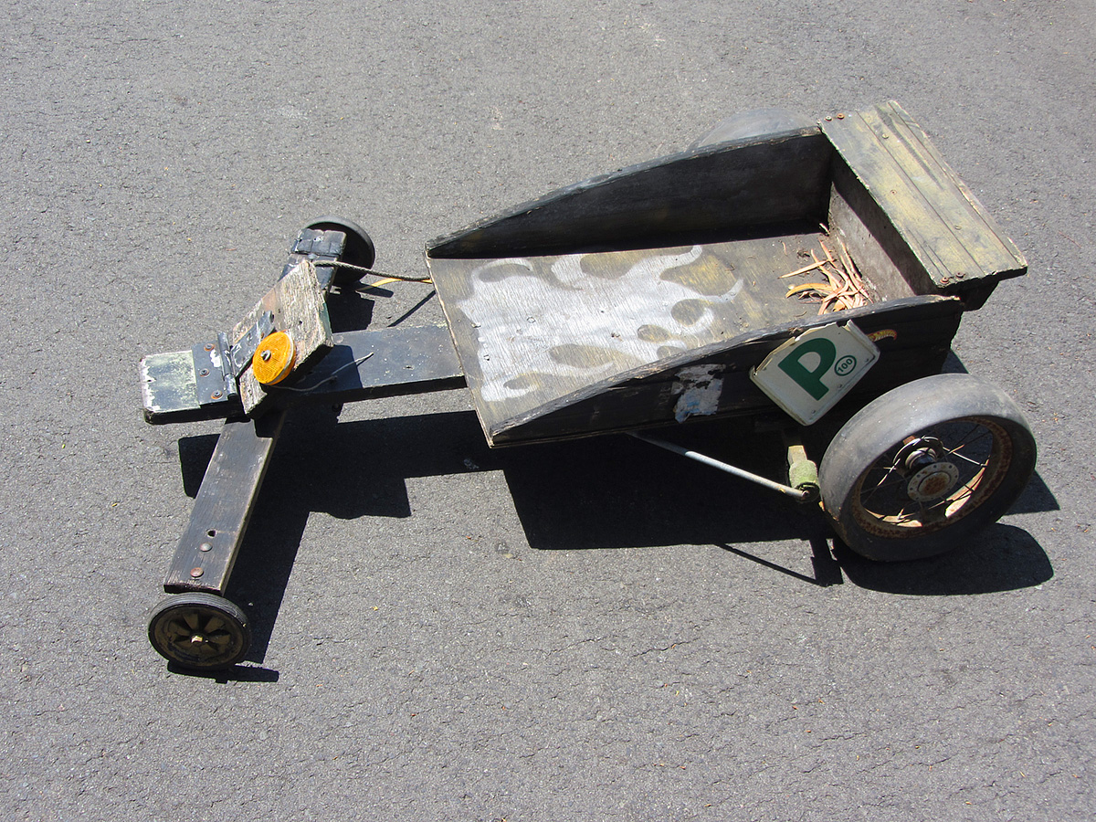 a small motorcycle trailer that is parked in the road