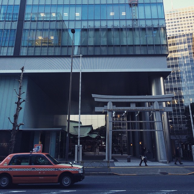 an orange car outside of an office building