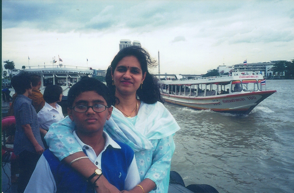 two people standing by the edge of a body of water