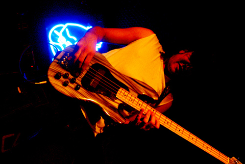 a person with an electric bass in their hand