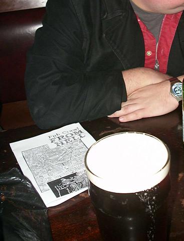 a man sits at a table with glasses on it