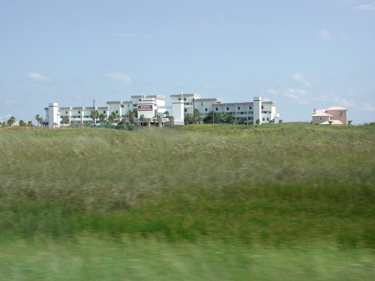 a big building with bushes in front of it