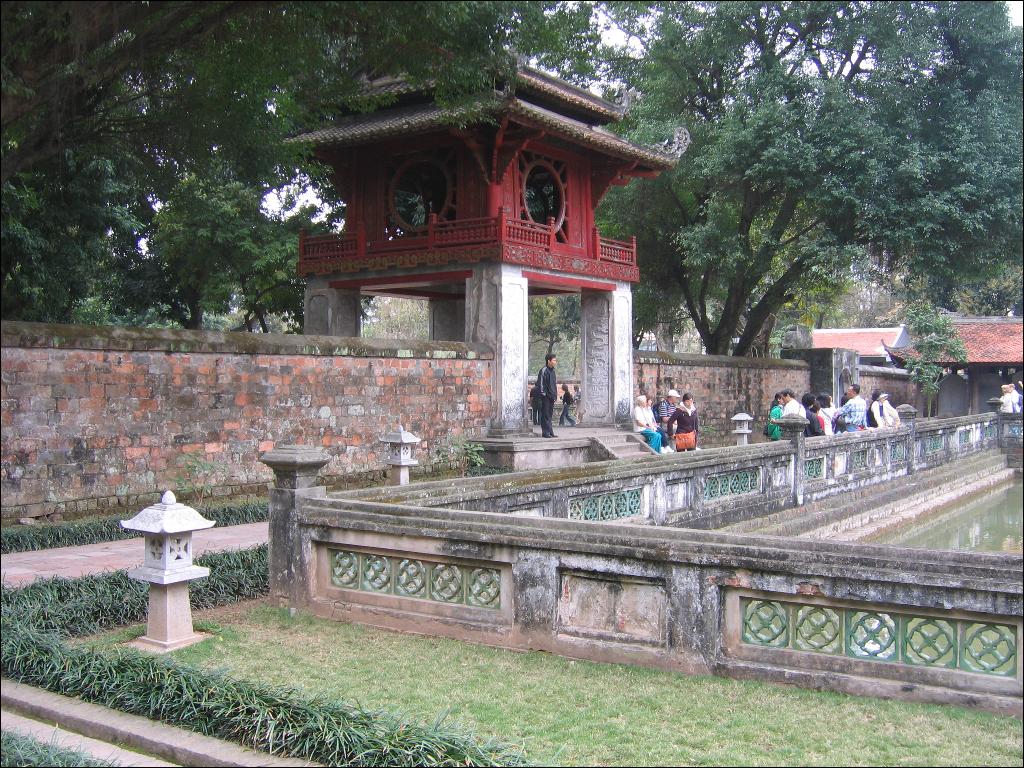 some people are at the entrance to a pagoda
