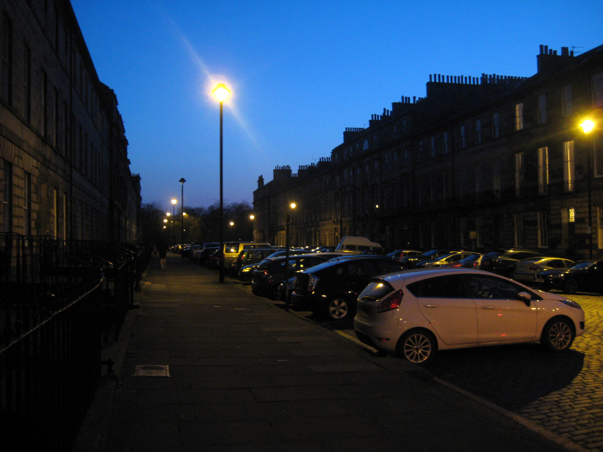 a bunch of cars are parked on the street