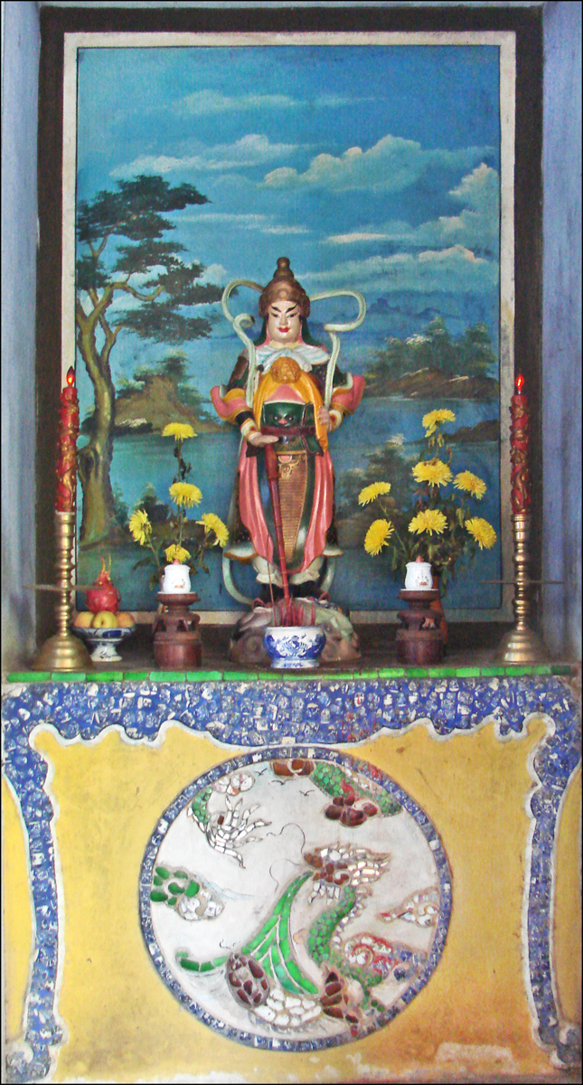 a painting with a large seated person and other decor