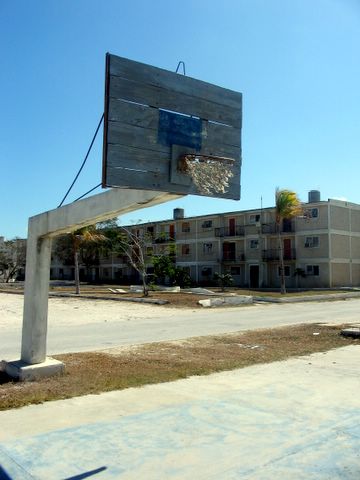 an old apartment building next to a basketball hoop