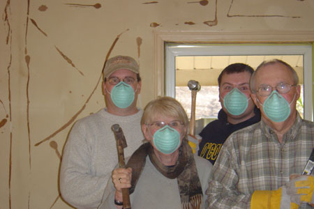 a group of people holding onto face masks