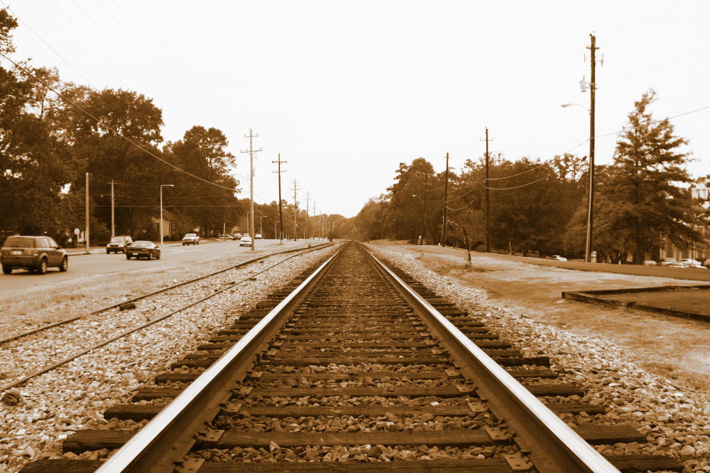 a brown and white po of an empty train track