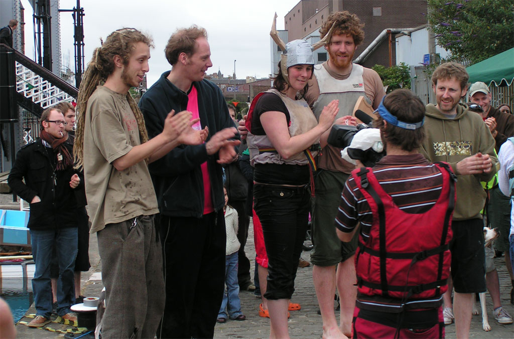 a crowd of young people with one holding a bat