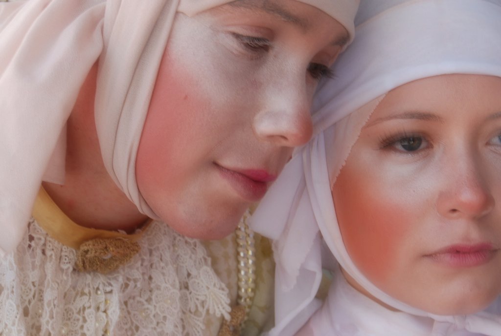 two people dressed in different traditional clothing pose together