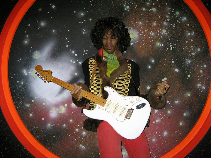 a man dressed in costume with a white guitar