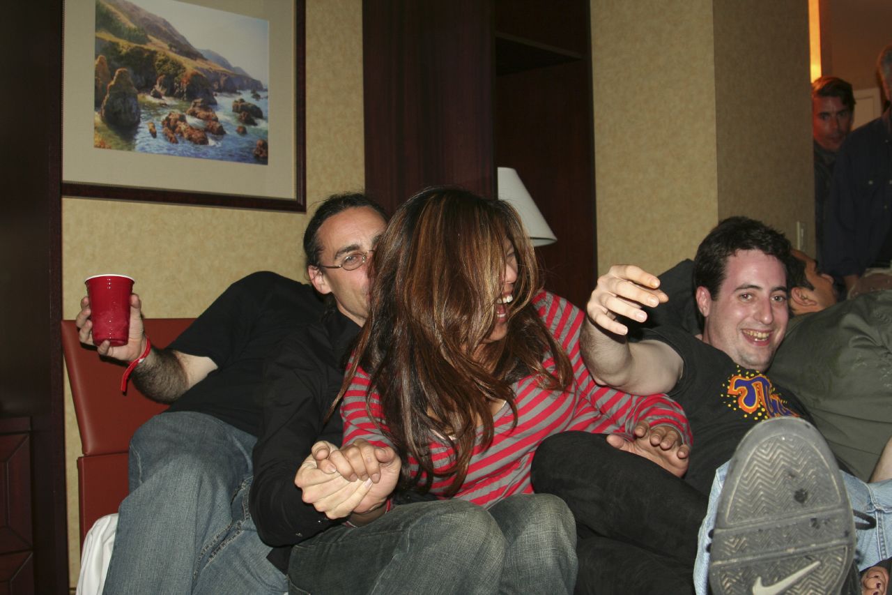 group of people sitting and laughing in a living room