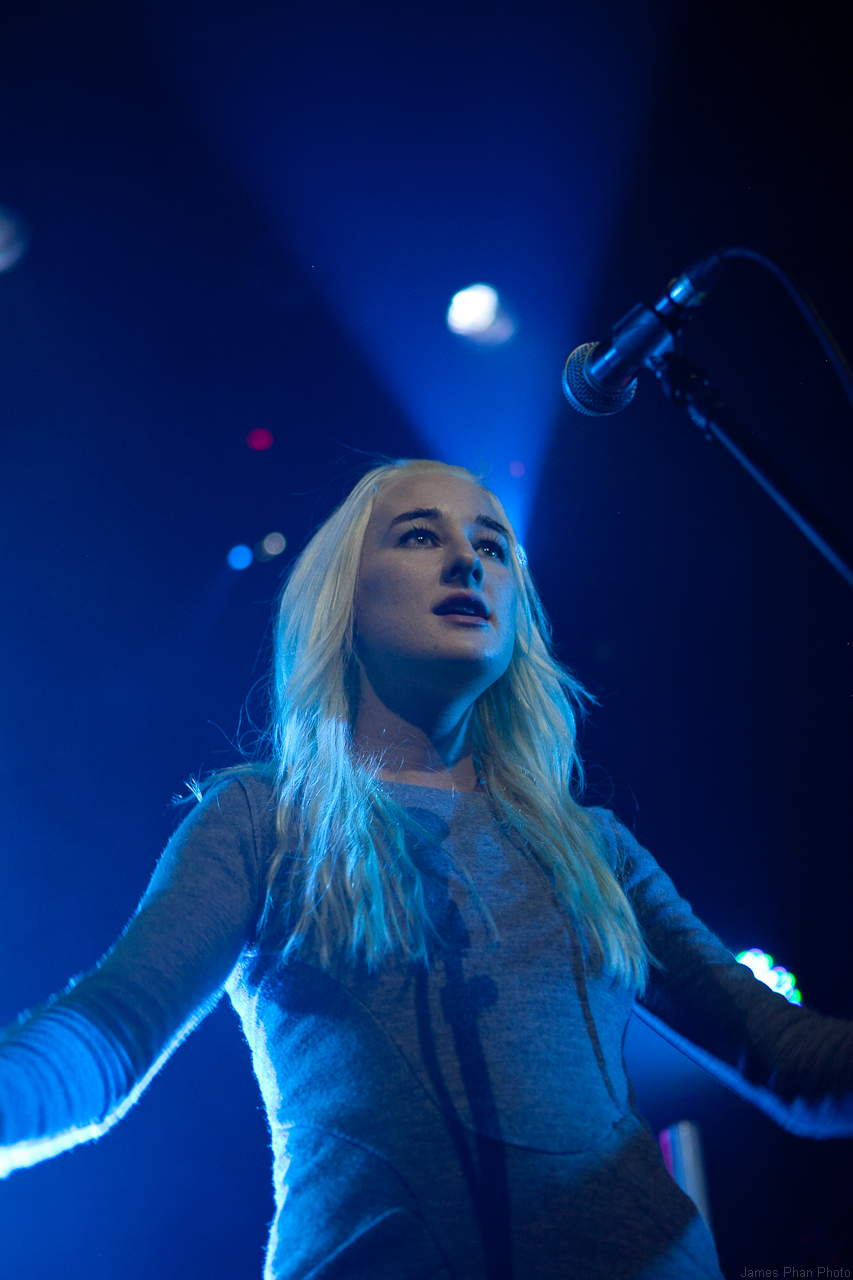 a woman is holding a microphone in her hand