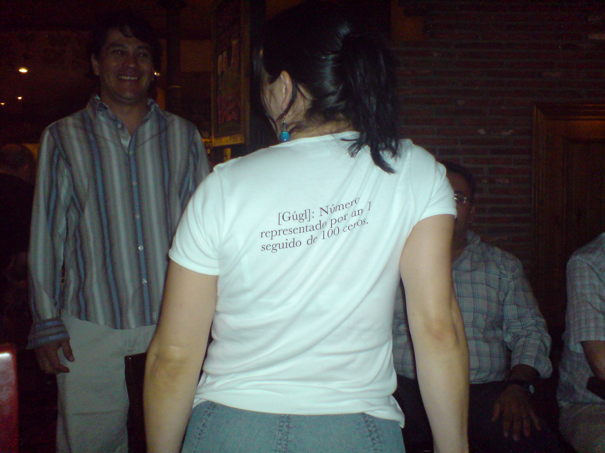 a woman wearing a white shirt has a message on the back