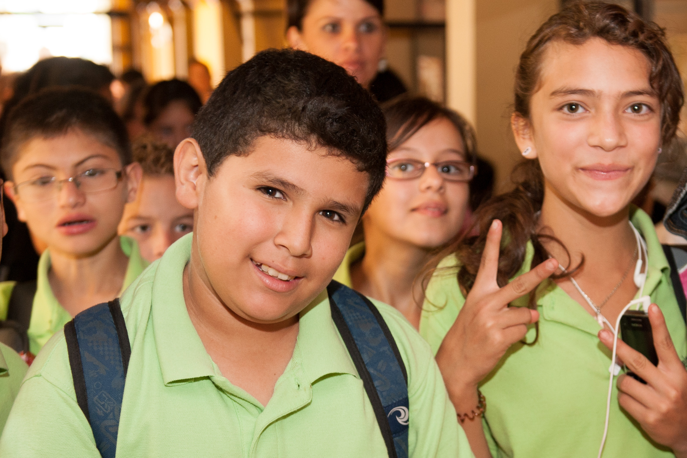 a group of children wearing school uniforms standing next to each other