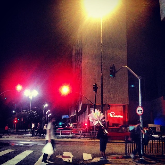 a person crossing the street at night in the city