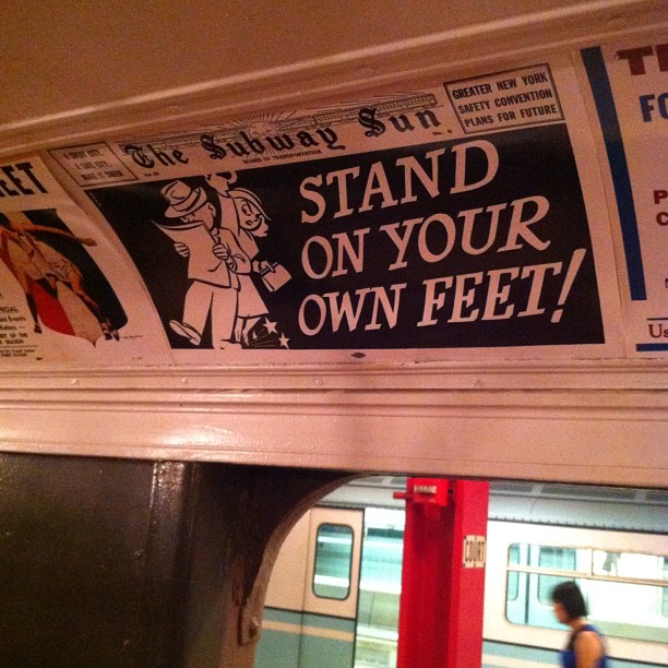 there is a train with a sign that says stand on your own feet
