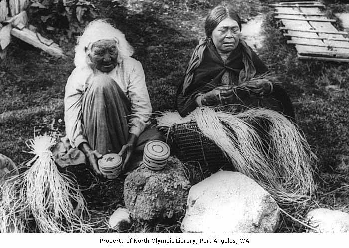 two women sitting next to each other holding baskets