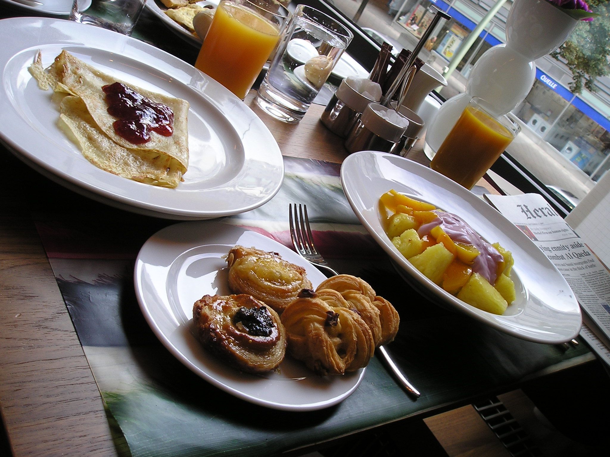 three plates full of pastry on top of a table