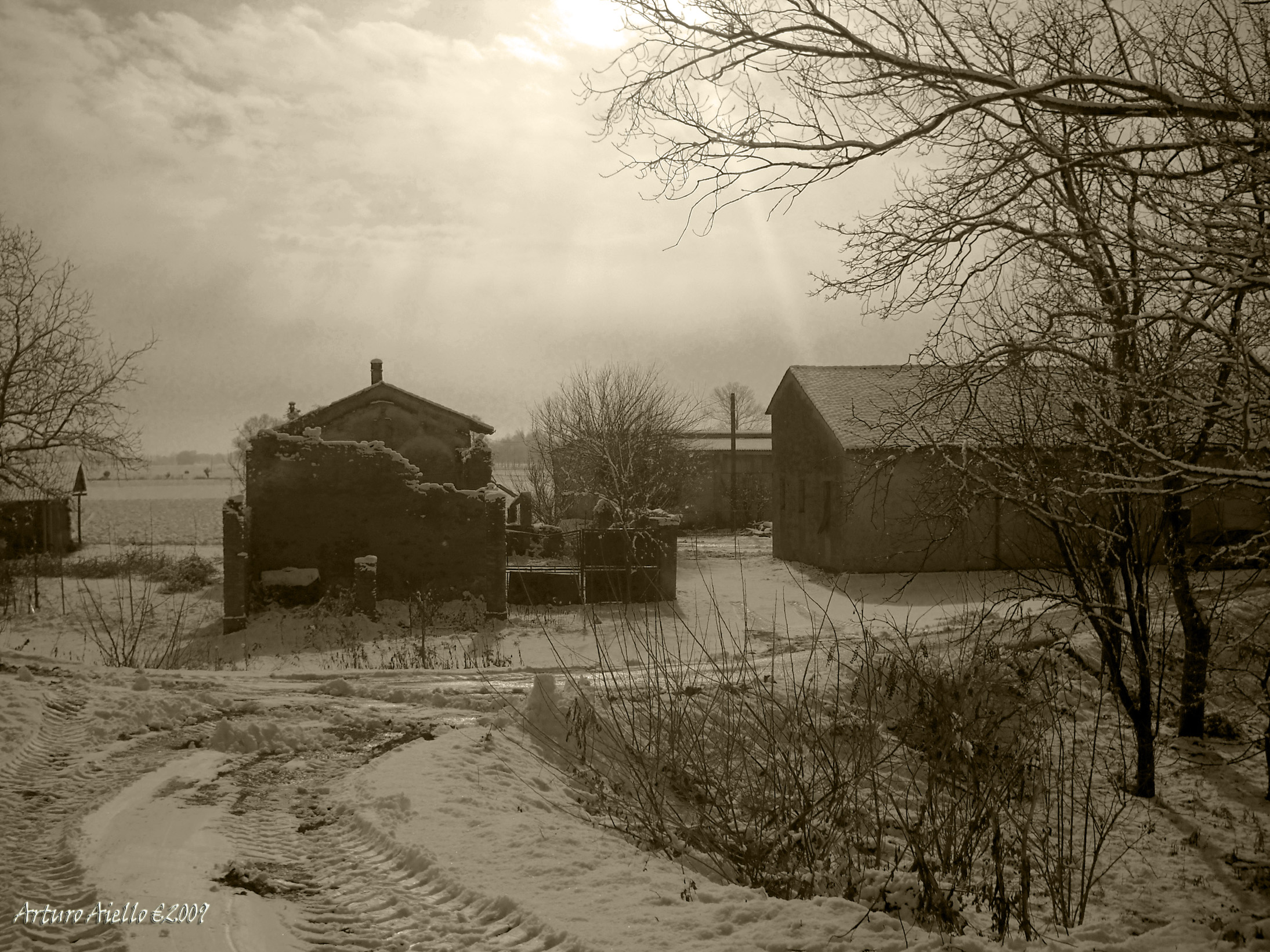 winter scene with barn and farm house in snowy field