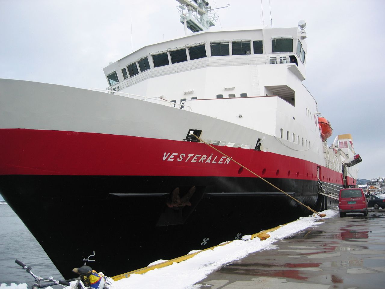 the big ferry is docked next to its smaller sister