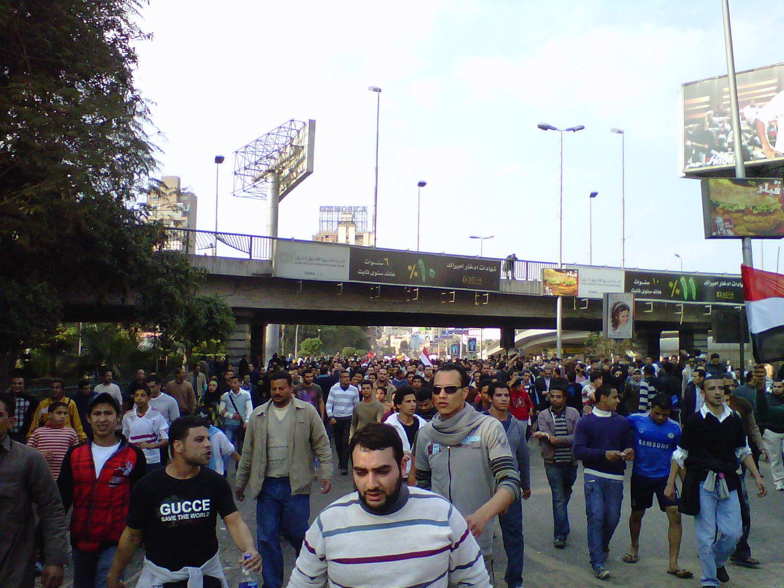 a crowd of people walking in an open area