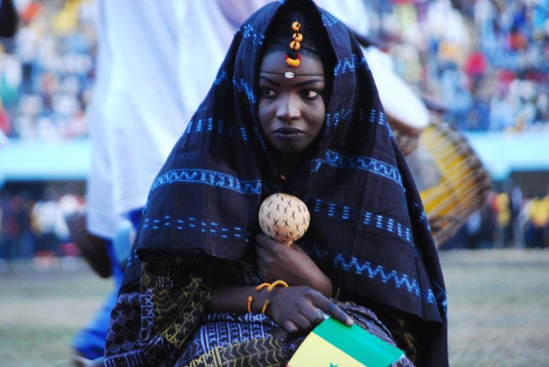 a woman in traditional clothing holds a ball