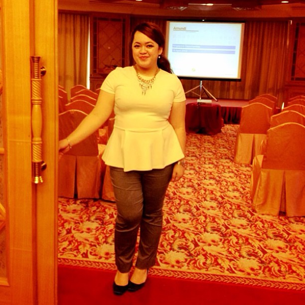 a smiling woman standing next to a doorway in a room