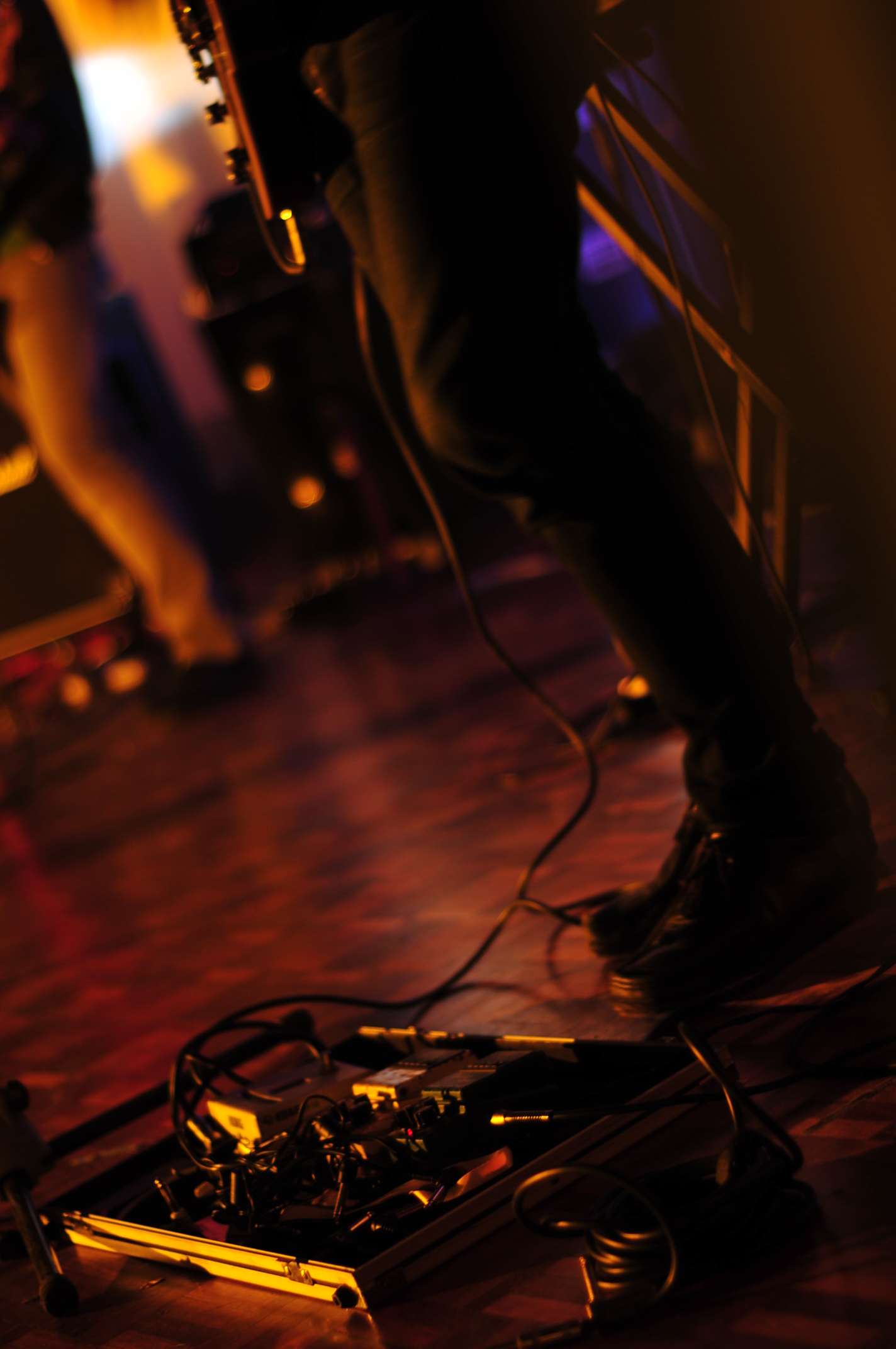 two people stand behind a keyboard with wires attached