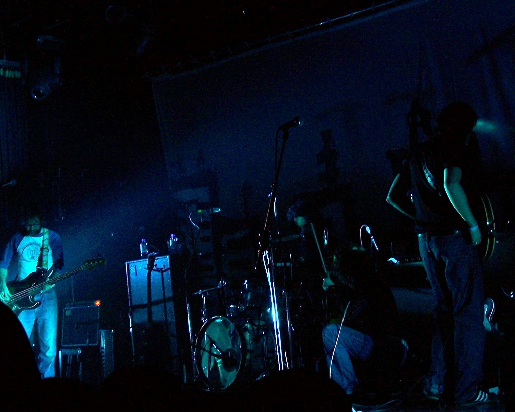 an image of band playing in the dark
