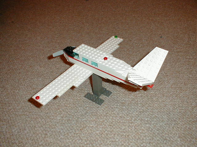 a lego airplane sitting on top of a carpeted floor