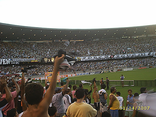 the fans at a sports stadium wave signs in the air