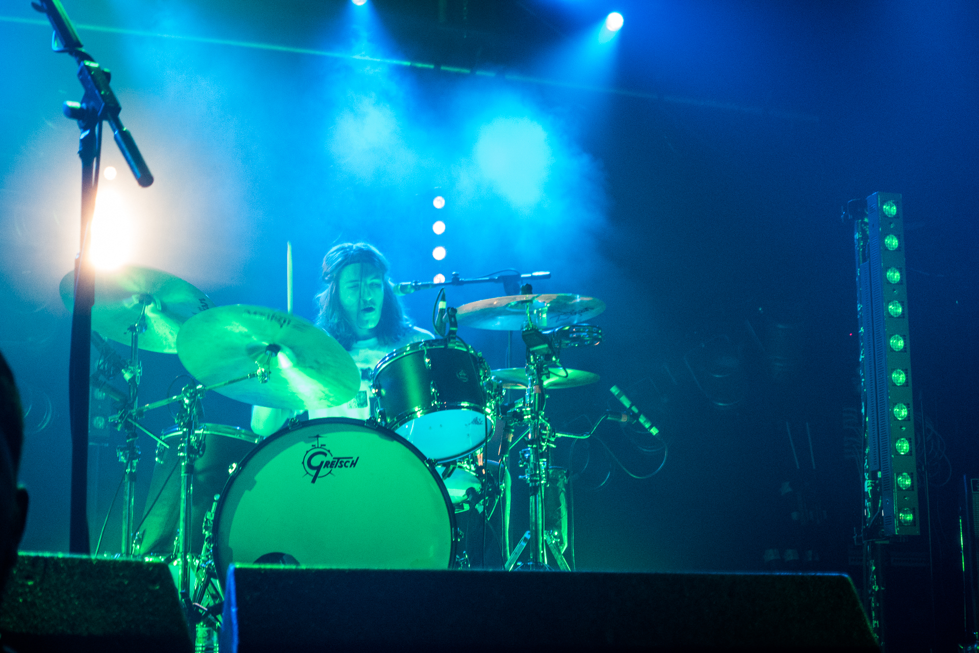 a group of musicians playing drums at a concert