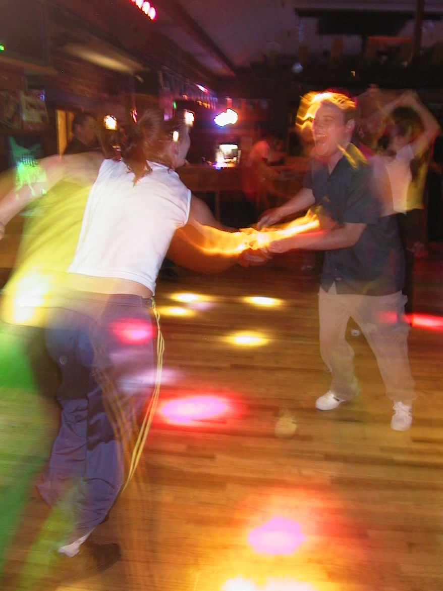 some people dancing in an event with blurred lights