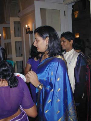 a woman with a bunch of people around her in the dark