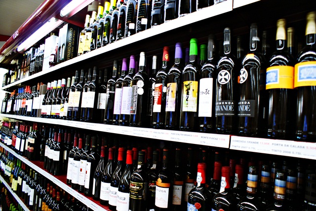 a store shelf full of alcohol on display