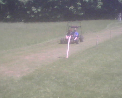 a couple of people driving on the back of a tractor