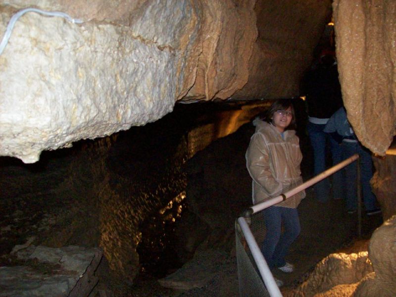 people are climbing up stairs in a cave