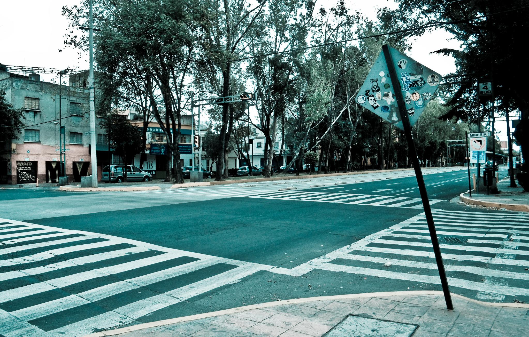 the empty road is at the corner of a street