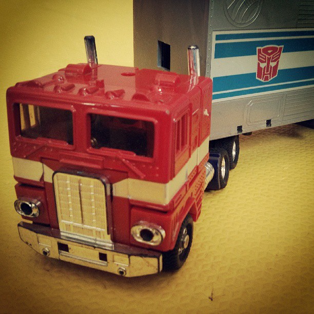 a close up of a toy truck with a truck on the back of it