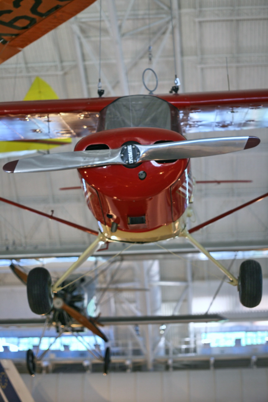 small red and gold plane hanging in a hanger
