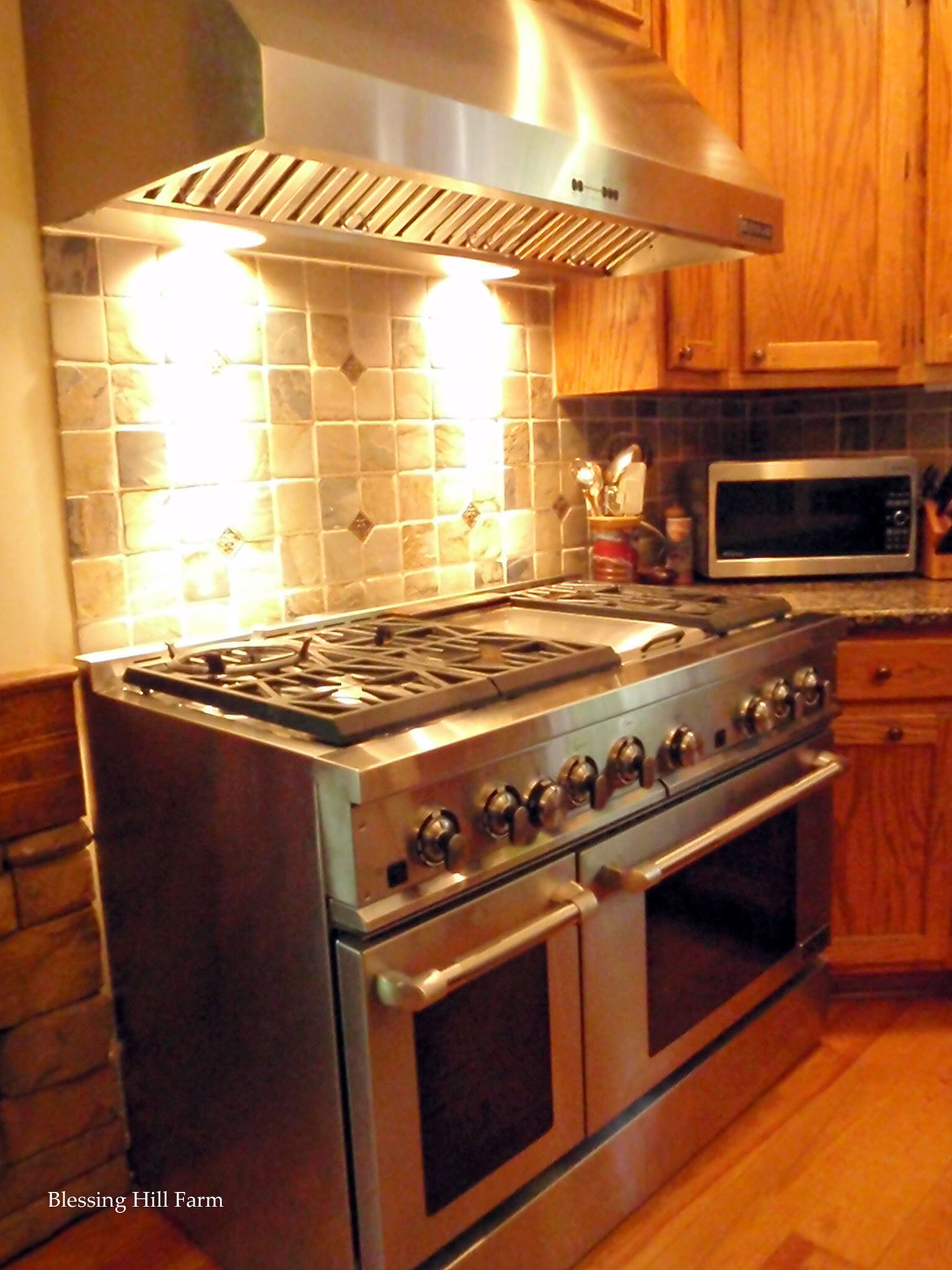an oven and range in a kitchen with lots of wooden cabinets