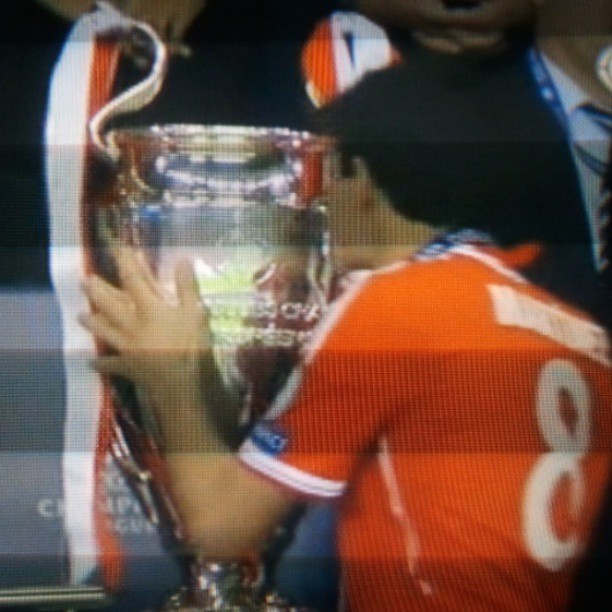 a soccer player is holding the trophy