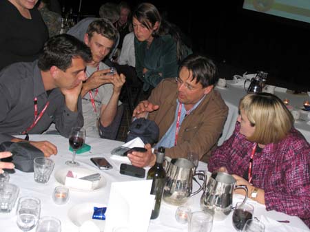 a group of people seated around a table drinking wine