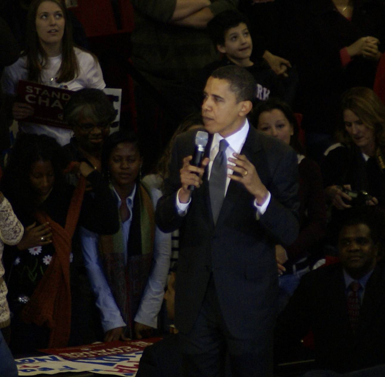 the president is holding a microphone near the audience