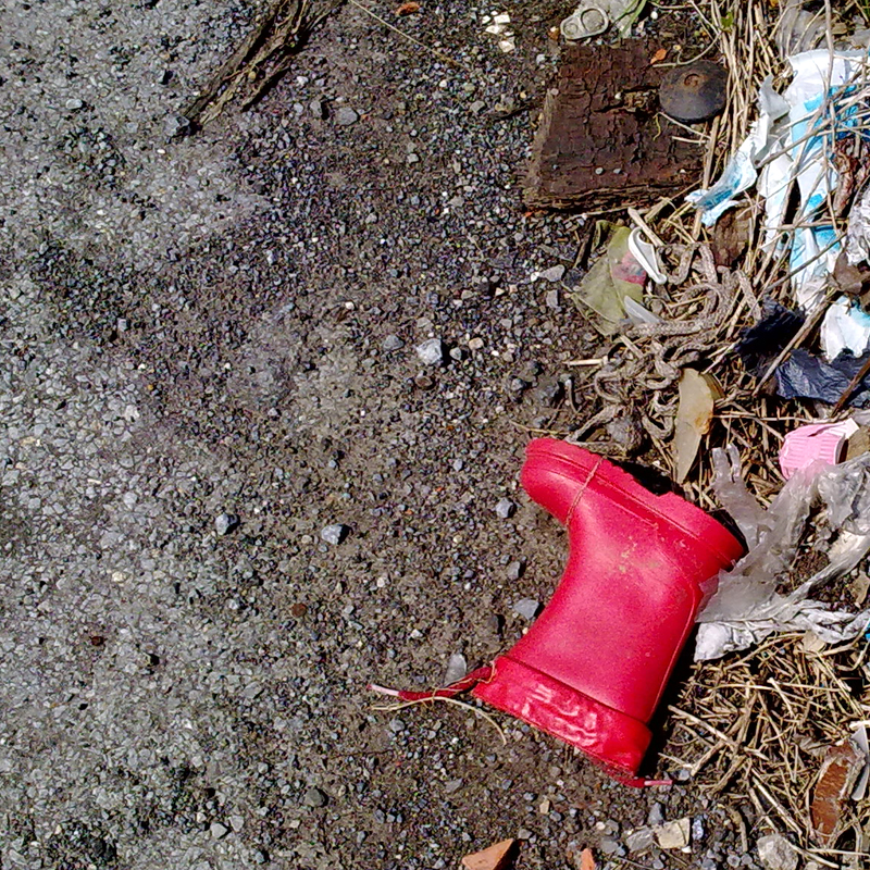 a close up of a red shoe sitting on the ground