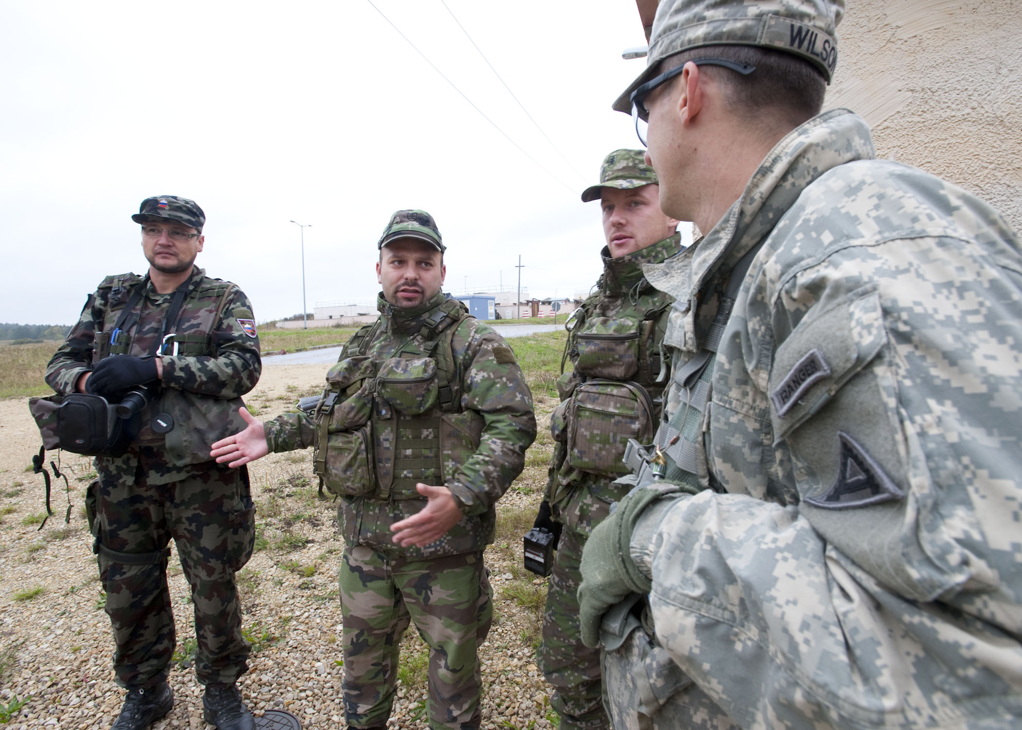 soldiers are gathered outside having a conversation